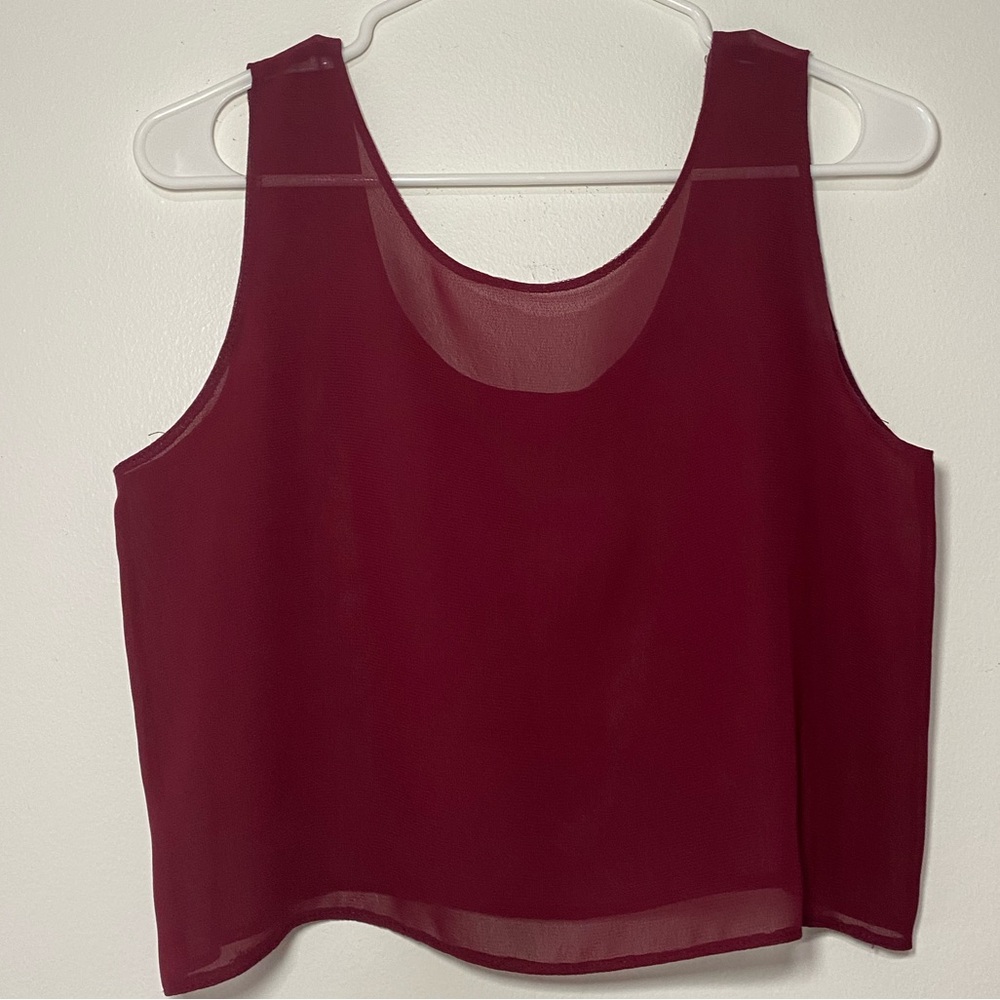 See-through crop top. Color: Dark red.